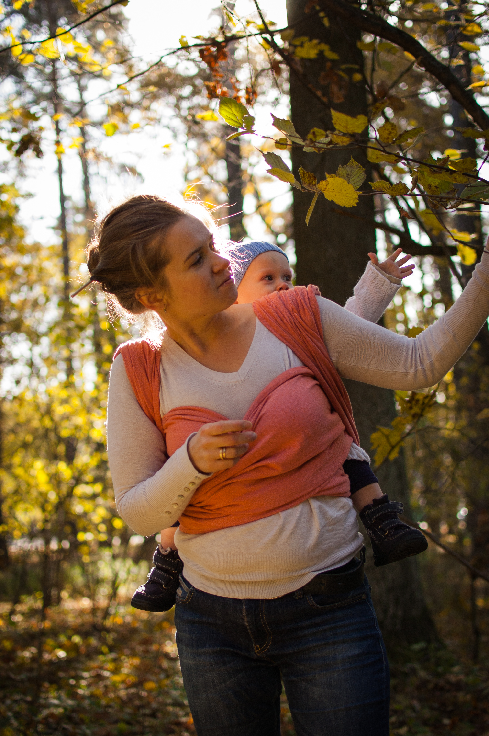 Woman carrying child in a woven wrap