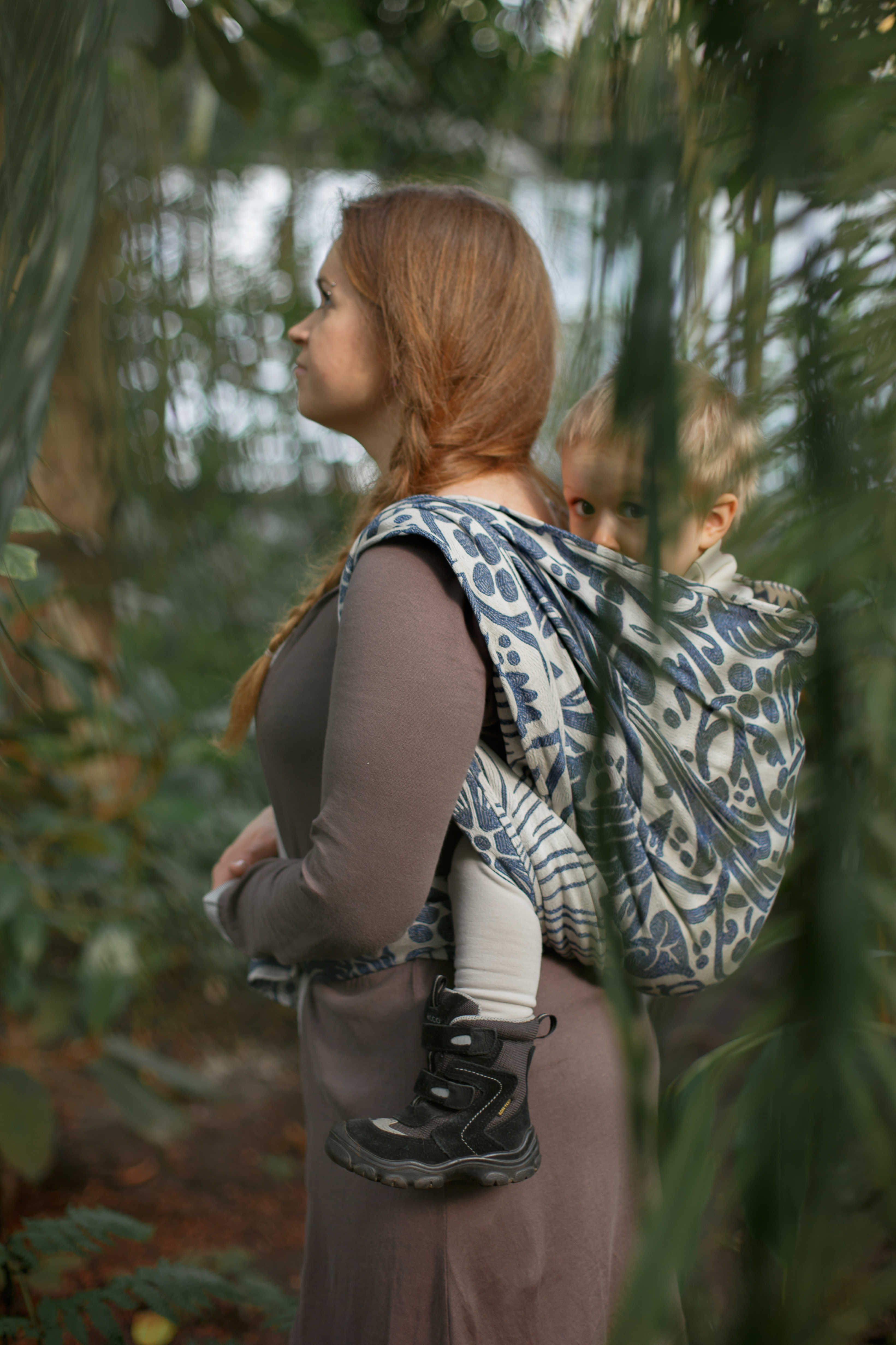 Woman carrying child in a woven wrap