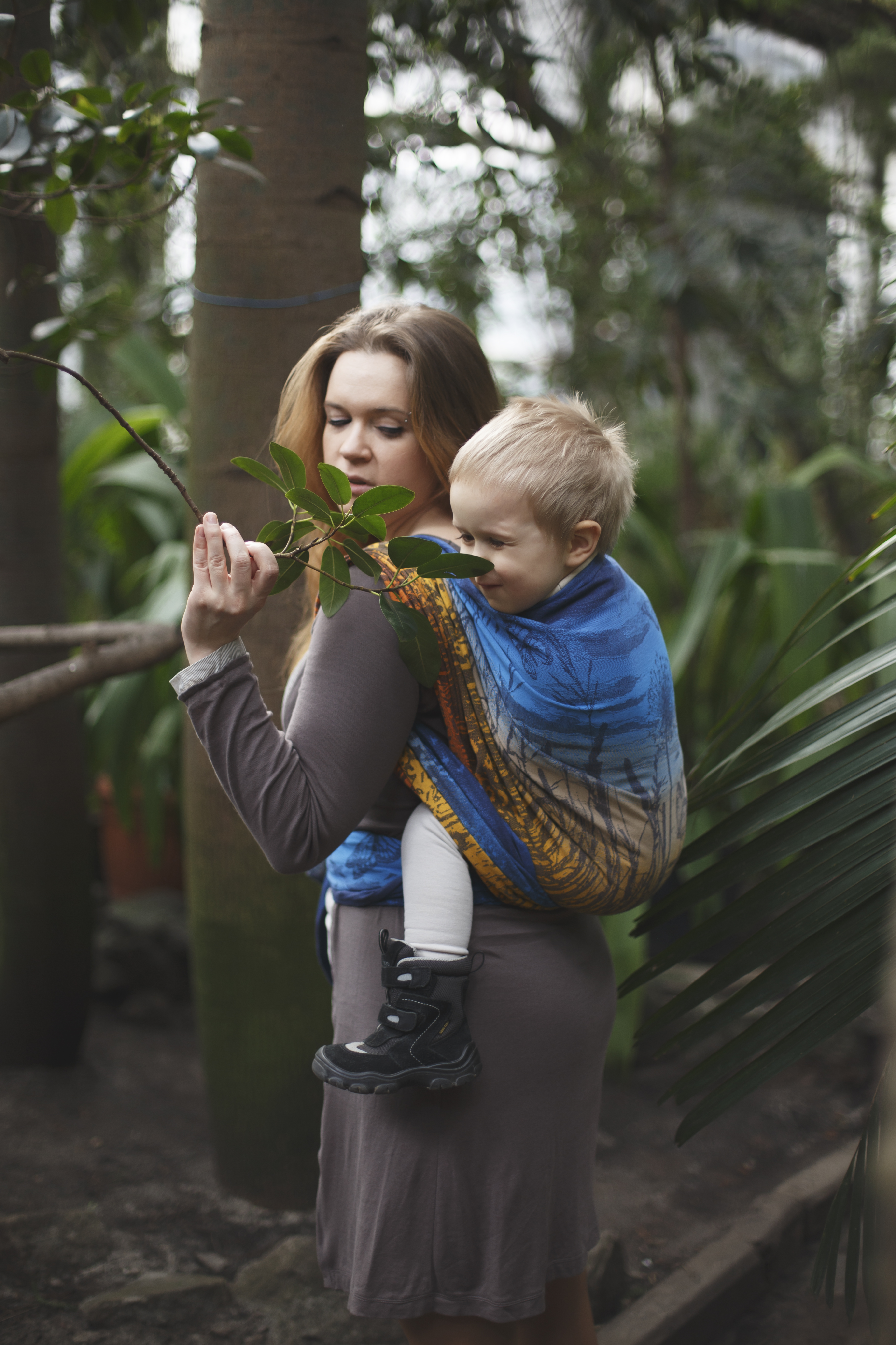 Woman carrying child in a woven wrap