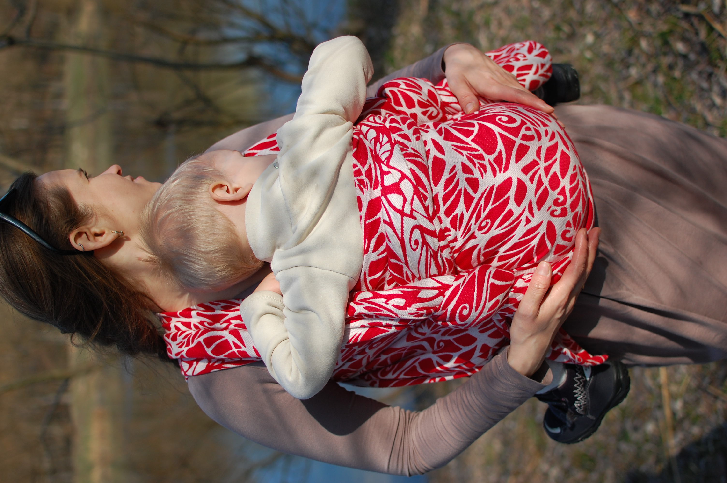 Woman carrying child in a woven wrap