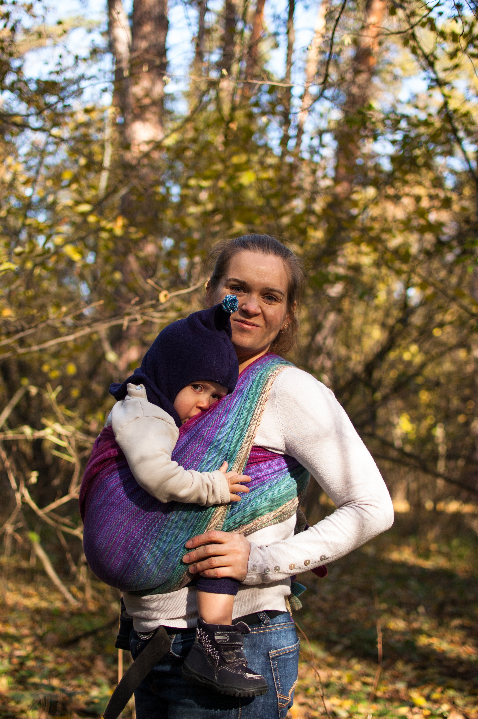 Woman carrying child in a woven wrap