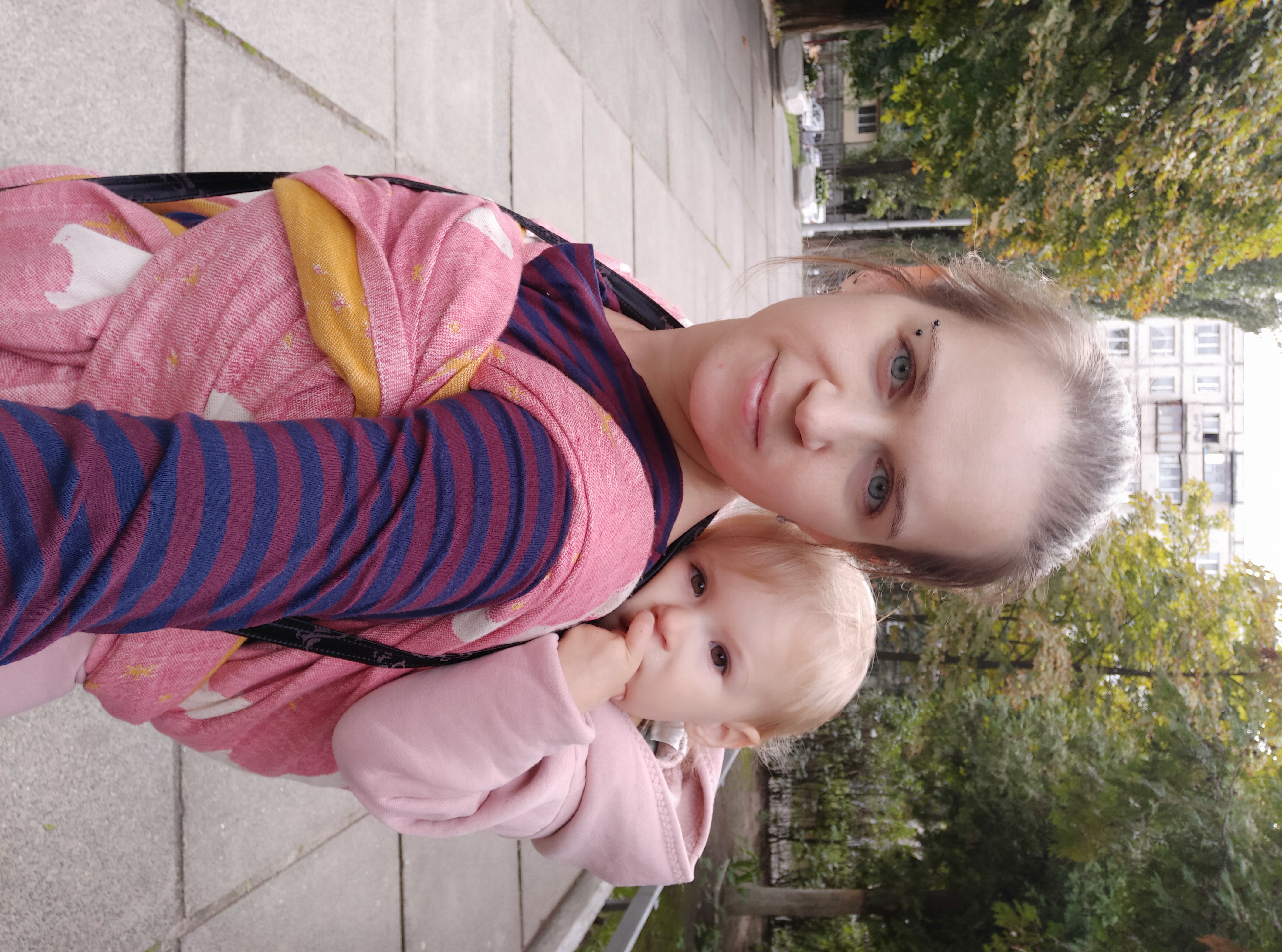 Woman carrying child in a woven wrap