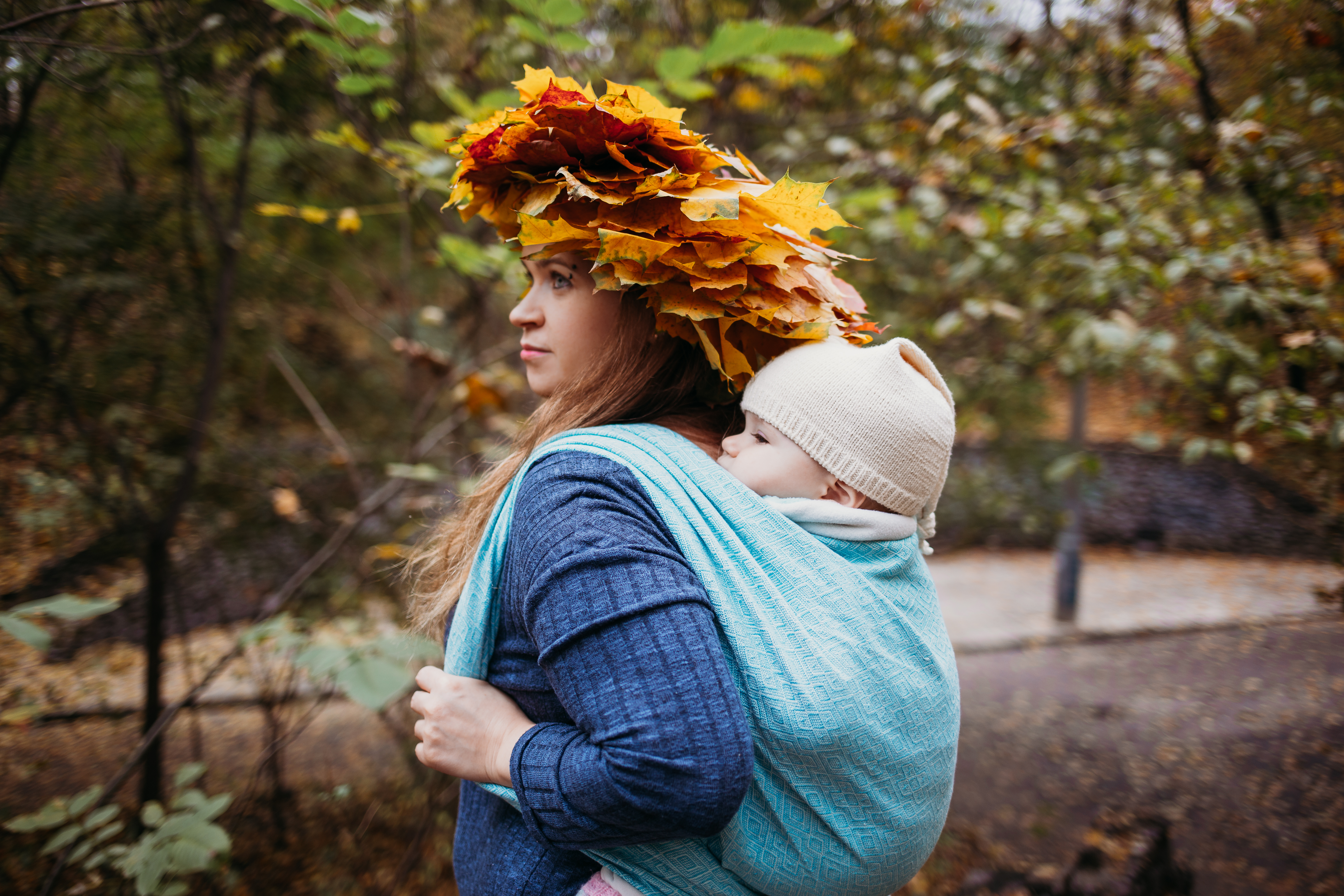 Woman carrying child in a woven wrap